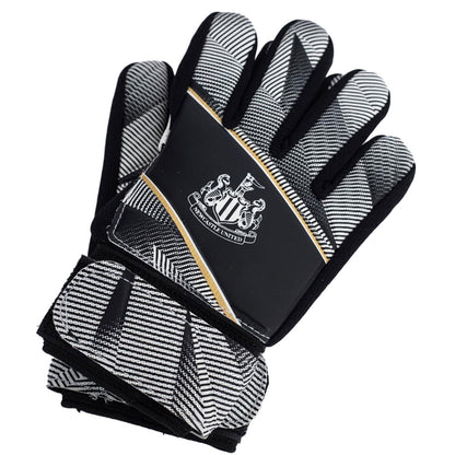 Black and white goalkeeper gloves with a Newcastle United logo on a white background
